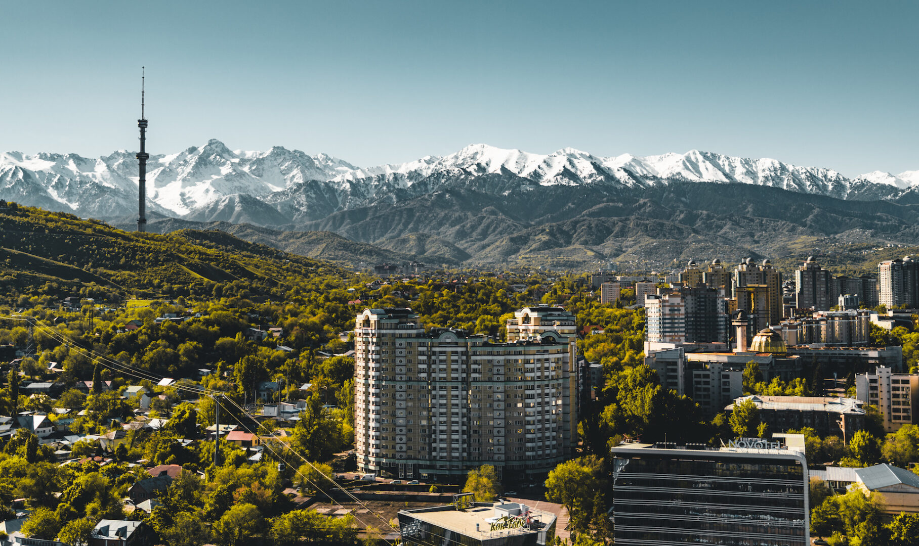 City landscape on a background of snow-capped Tian Shan mountains in Almaty Kazakhstan